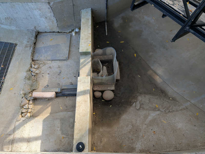 Reservoir dam wall with no dirt and few leaves