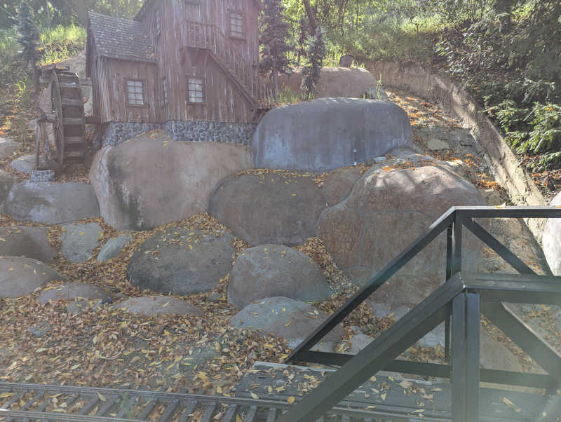 Water wheel house with lots of leaves